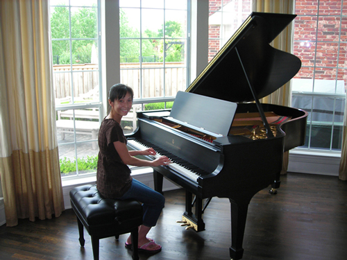 Satisfied client sitting at her newly rebuilt piano.