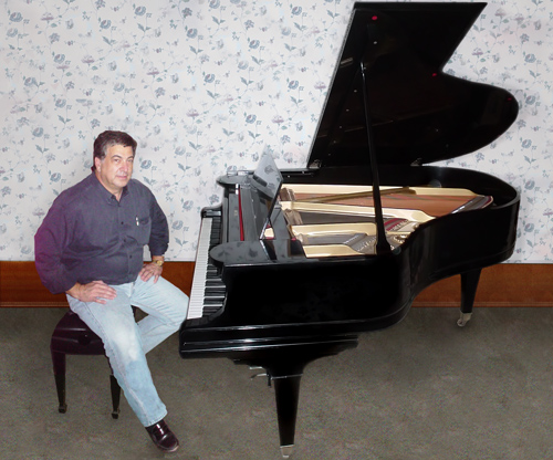 Satisfied customer sitting at his newly rebuilt piano.